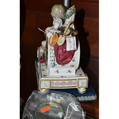 504 - A LATE 19TH CENTURY MEISSEN PORCELAIN CLOCK CASE, modelled with a seated putto reading, arm resting ... 