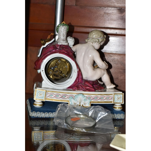 504 - A LATE 19TH CENTURY MEISSEN PORCELAIN CLOCK CASE, modelled with a seated putto reading, arm resting ... 