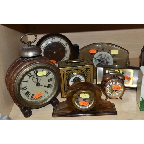 516 - A GROUP OF MID-CENTURY CLOCKS, eleven clocks, comprising a wall clock made from a Ford dealer's larg... 