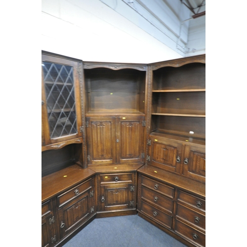 1290 - A JAYCEE OAK LINENFOLD CORNER SHELVING UNIT, with an arrangement of cupboards, shelves, and drawers,... 