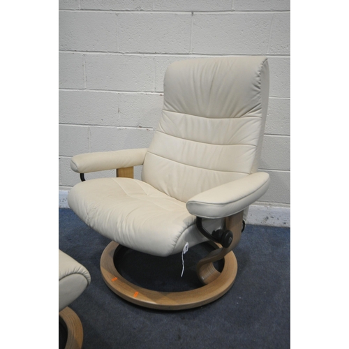 1299 - AN EKORNES STRESSLESS CREAM LEATHER RECLINING SWIVEL ARMCHAIR, with footstool (condition report: goo... 