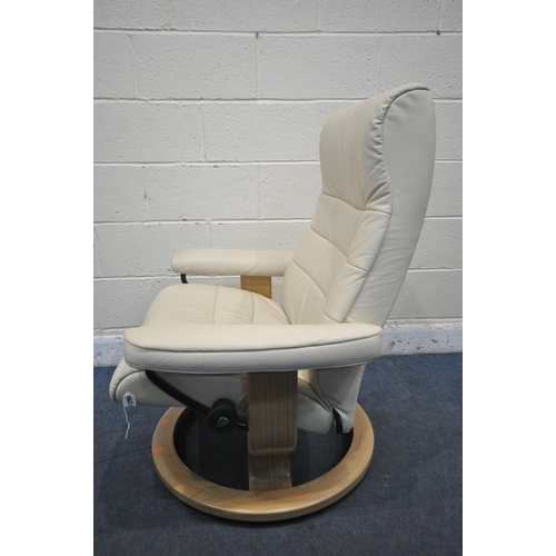 1299 - AN EKORNES STRESSLESS CREAM LEATHER RECLINING SWIVEL ARMCHAIR, with footstool (condition report: goo... 