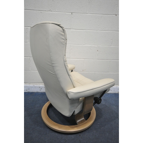 1299 - AN EKORNES STRESSLESS CREAM LEATHER RECLINING SWIVEL ARMCHAIR, with footstool (condition report: goo... 