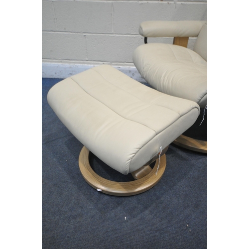 1299 - AN EKORNES STRESSLESS CREAM LEATHER RECLINING SWIVEL ARMCHAIR, with footstool (condition report: goo... 