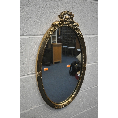 1301 - TWO GILT FRAMED OVAL WALL MIRRORS (condition report: small chip to one mirror)