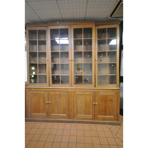 1302 - A LARGE 19TH CENTURY OAK BOOKCASE, the top breakfront section fitted with four astragal glazed doors... 