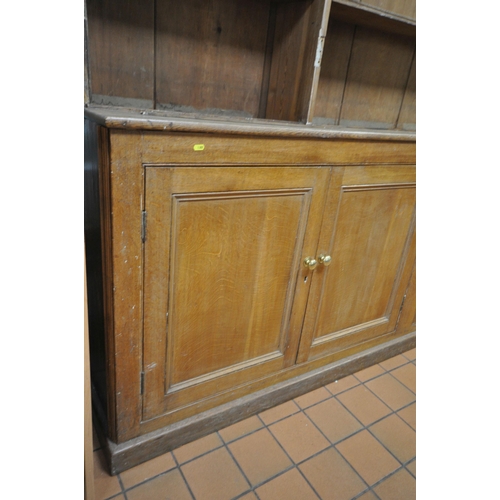 1302 - A LARGE 19TH CENTURY OAK BOOKCASE, the top breakfront section fitted with four astragal glazed doors... 