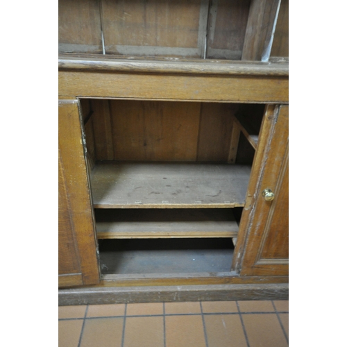 1302 - A LARGE 19TH CENTURY OAK BOOKCASE, the top breakfront section fitted with four astragal glazed doors... 