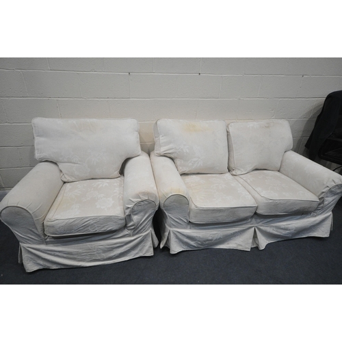 1308 - A CREAM COVERED TWO PIECE LOUNGE SUITE, comprising a two seater settee, and a pair of armchairs (con... 