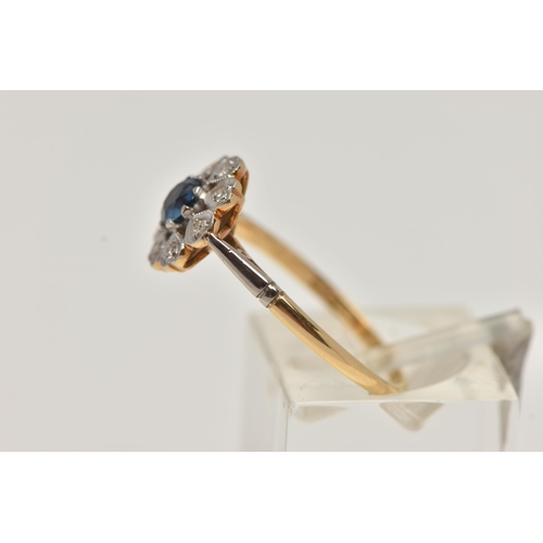 102 - AN 18CT GOLD SAPPHIRE AND DIAMOND RING, principle set circular cut sapphire with a surround of eight... 