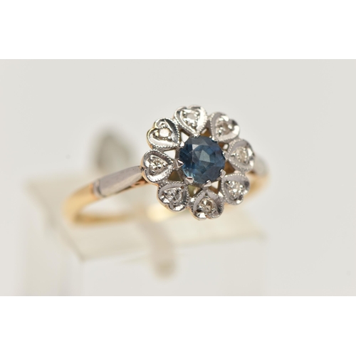 102 - AN 18CT GOLD SAPPHIRE AND DIAMOND RING, principle set circular cut sapphire with a surround of eight... 