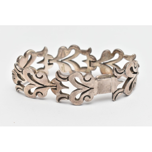 107 - A HEAVY WHITE METAL BRACELET, abstract foliage design, fitted with an integrated folding box clasp, ... 