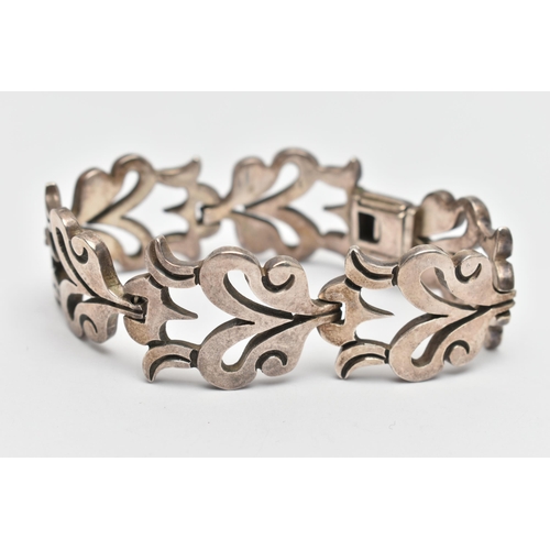 107 - A HEAVY WHITE METAL BRACELET, abstract foliage design, fitted with an integrated folding box clasp, ... 