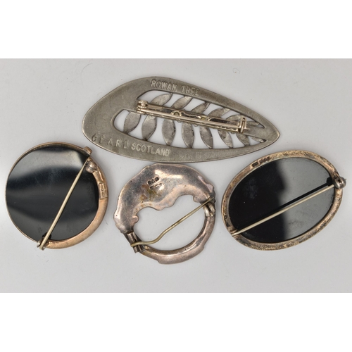 109 - FOUR SILVER AND WHITE METAL BROOCHES, the first an oval onyx brooch with silver fittings, hallmarked... 