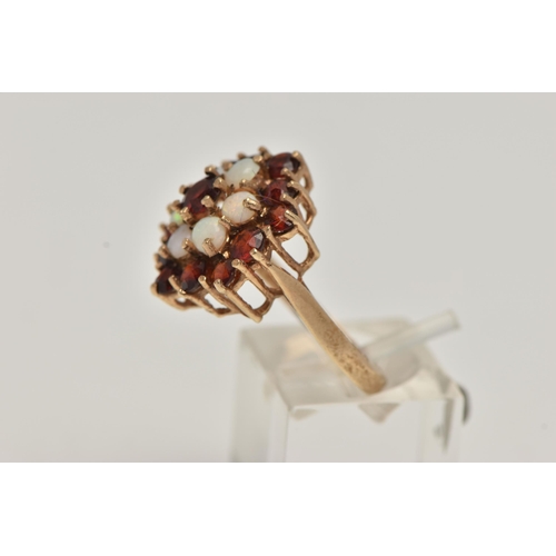 15 - A 9CT GOLD GARNET AND OPAL CLUSTER DRESS RING, comprised of thirteen circular cut garnets and six ci... 