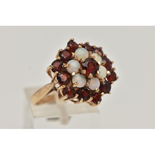 15 - A 9CT GOLD GARNET AND OPAL CLUSTER DRESS RING, comprised of thirteen circular cut garnets and six ci... 