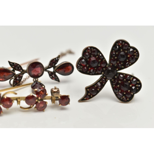 16 - THREE EARLY 20TH CENTURY GARNET BROOCHES, two bar brooches and a clover bohemian garnet brooch, (con... 