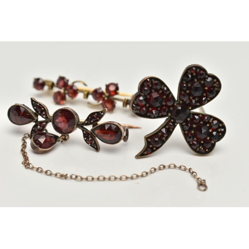 16 - THREE EARLY 20TH CENTURY GARNET BROOCHES, two bar brooches and a clover bohemian garnet brooch, (con... 