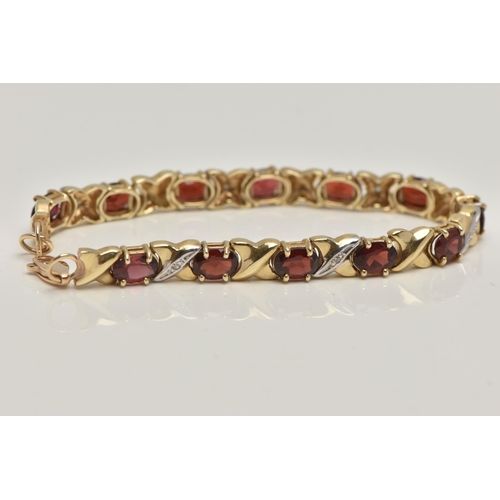 17 - A 9CT GOLD AND GARNET BRACELET, twelve oval cut garnets, prong set in yellow metal, interspaced betw... 