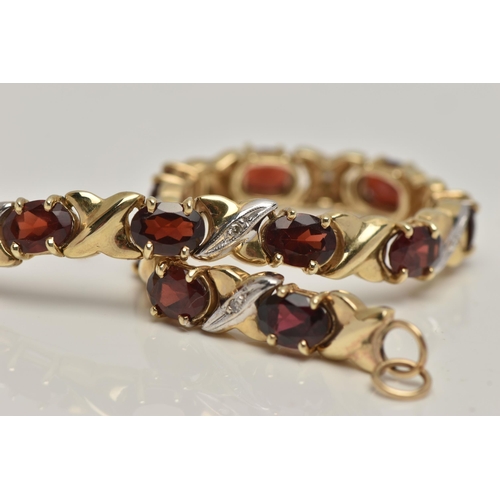 17 - A 9CT GOLD AND GARNET BRACELET, twelve oval cut garnets, prong set in yellow metal, interspaced betw... 