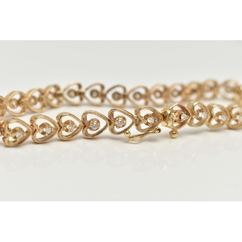 28 - A YELLOW METAL AND DIAMOND BRACELET,  heart link bracelet, each link set with a round brilliant cut ... 