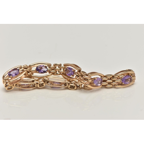 57 - A 9CT GOLD AMETHYST BRACELET, seven oval cut amethyst prong set in yellow gold, interspaced between ... 