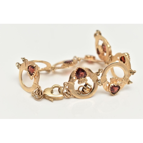 60 - A 9CT GOLD AND GARNET CLADDAGH BRACELET, nine circular claddagh links, each set with a heart cut gar... 