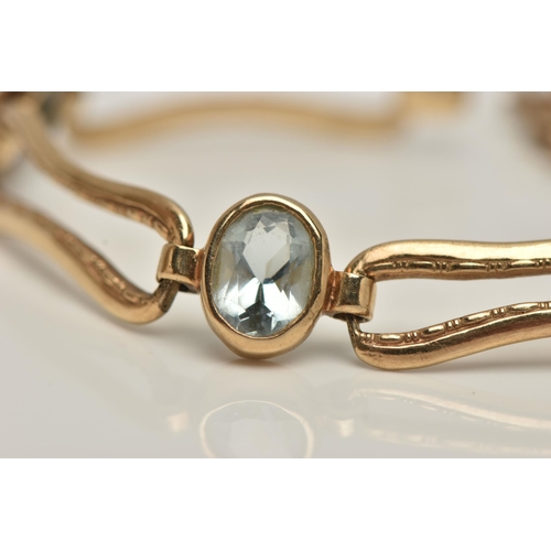 7 - AN AQUAMARINE BRACELET, five oval cut aquamarines bezel set in yellow metal interspaced between elon... 