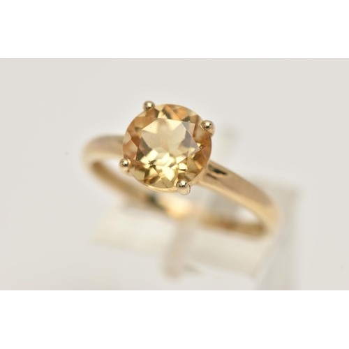 70 - A 9CT GOLD CITRINE RING, the circular cut Citrine within a four claw setting to the plain band, with... 