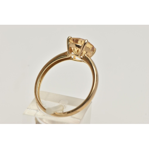 70 - A 9CT GOLD CITRINE RING, the circular cut Citrine within a four claw setting to the plain band, with... 