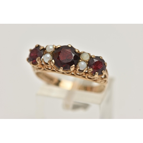 72 - A 9CT GOLD GARNET AND SPLIT PEARL RING, designed as three graduated circular garnets interspaced by ... 