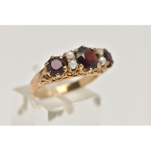 72 - A 9CT GOLD GARNET AND SPLIT PEARL RING, designed as three graduated circular garnets interspaced by ... 