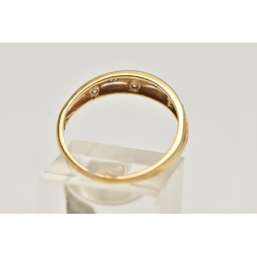 73 - AN 18CT GOLD DIAMOND DRESS RING, the tapered band with pierced detail, flush set with six brilliant ... 