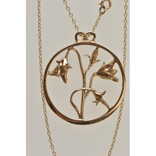 9 - A 9CT GOLD OPEN WORK FLORAL NECKLACE, a large yellow gold circular pendant with an arrangement of fl... 