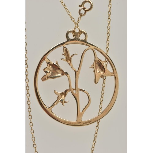 9 - A 9CT GOLD OPEN WORK FLORAL NECKLACE, a large yellow gold circular pendant with an arrangement of fl... 