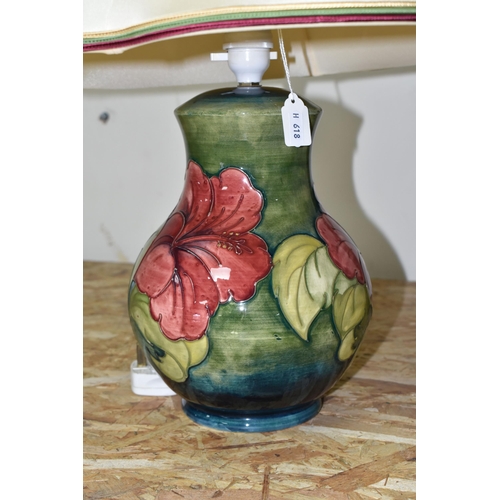 367 - A MOORCROFT POTTERY 'HIBISCUS' TABLE LAMP, decorated with red and yellow Hibiscus on a green ground,... 