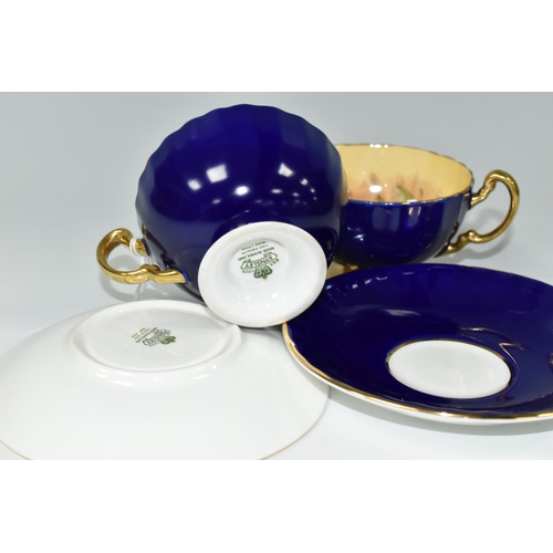 398 - TWO AYNSLEY ORCHARD GOLD TEACUPS AND SAUCERS, each teacup having gently fluted bowl, cobalt blue ext... 