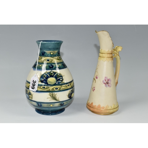 399 - A 1930s MOORCROFT POTTERY VASE AND A ROYAL WORCESTER BLUSH IVORY JUG, the Moorcroft baluster vase in... 