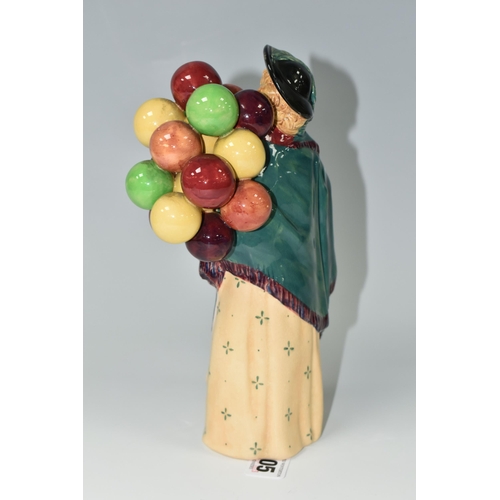 405 - A ROYAL DOULTON FIGURINE - 'THE BALLOON SELLER', model no HN583, issued 1923-1949, green printed bac... 