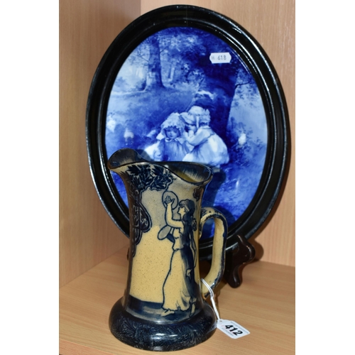 412 - A ROYAL DOULTON BLUE CHILDREN PLAQUE AND A MORRISIAN WARE JUG, the framed oval plaque decorated with... 