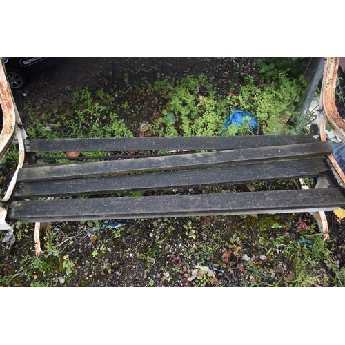 1005 - A DISTRESSED GARDEN BENCH, with wooden slats and cast iron ends, length 160cm (condition report: som... 