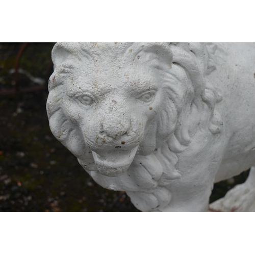 1013 - AN OPPOSING PAIR OF WHITE PAINTED COMPOSITE LIONS, with turned heads, and one front foot raised, len... 