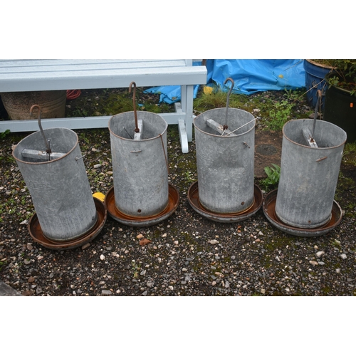 1015 - FOUR ELTEX GALVANISED CHICKEN FEEDERS, height approximately 70cm (condition report: rusty finish, so... 