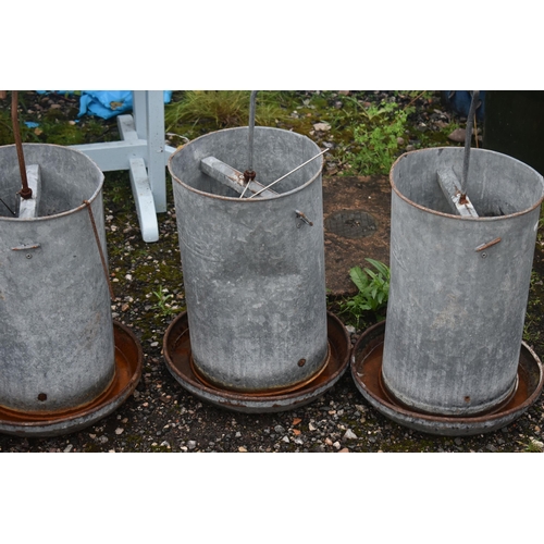 1015 - FOUR ELTEX GALVANISED CHICKEN FEEDERS, height approximately 70cm (condition report: rusty finish, so... 