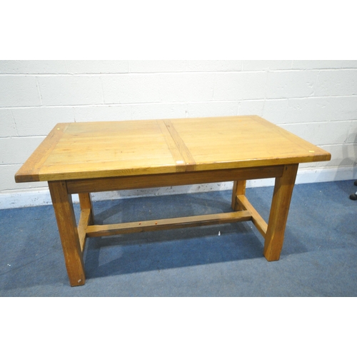 1227 - A LIGHT OAK EXTENDING DINING TABLE, with two drawers, on block legs, united by a H stretcher, extend... 