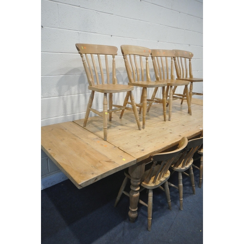 1253 - A LARGE PINE KITCHEN TABLE, with two additional leaves at each end, on turned legs, extended length ... 