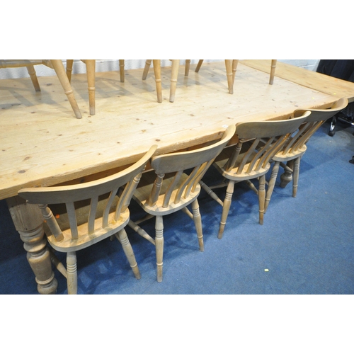 1253 - A LARGE PINE KITCHEN TABLE, with two additional leaves at each end, on turned legs, extended length ... 