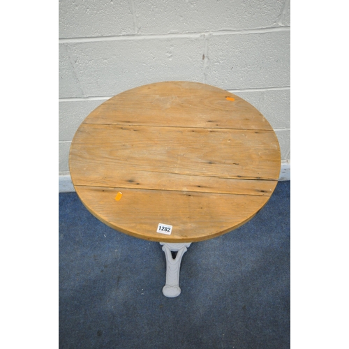 1282 - A PAINTED CAST IRON PUB TABLE, with a pine circular top (condition report: historical cracks)