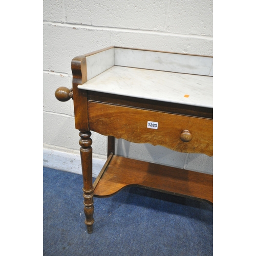 1283 - A VICTORIAN FLAME MAHOGANY WASHSTAND, with a marble top and gallery, towel rails flanking a single d... 