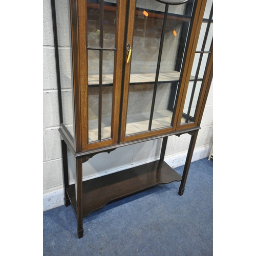 1284 - AN EDWARDIAN MAHOGANY ASTRAGAL GLAZED SINGLE DOOR DISPLAY CABINET, on square tapered legs, united by... 